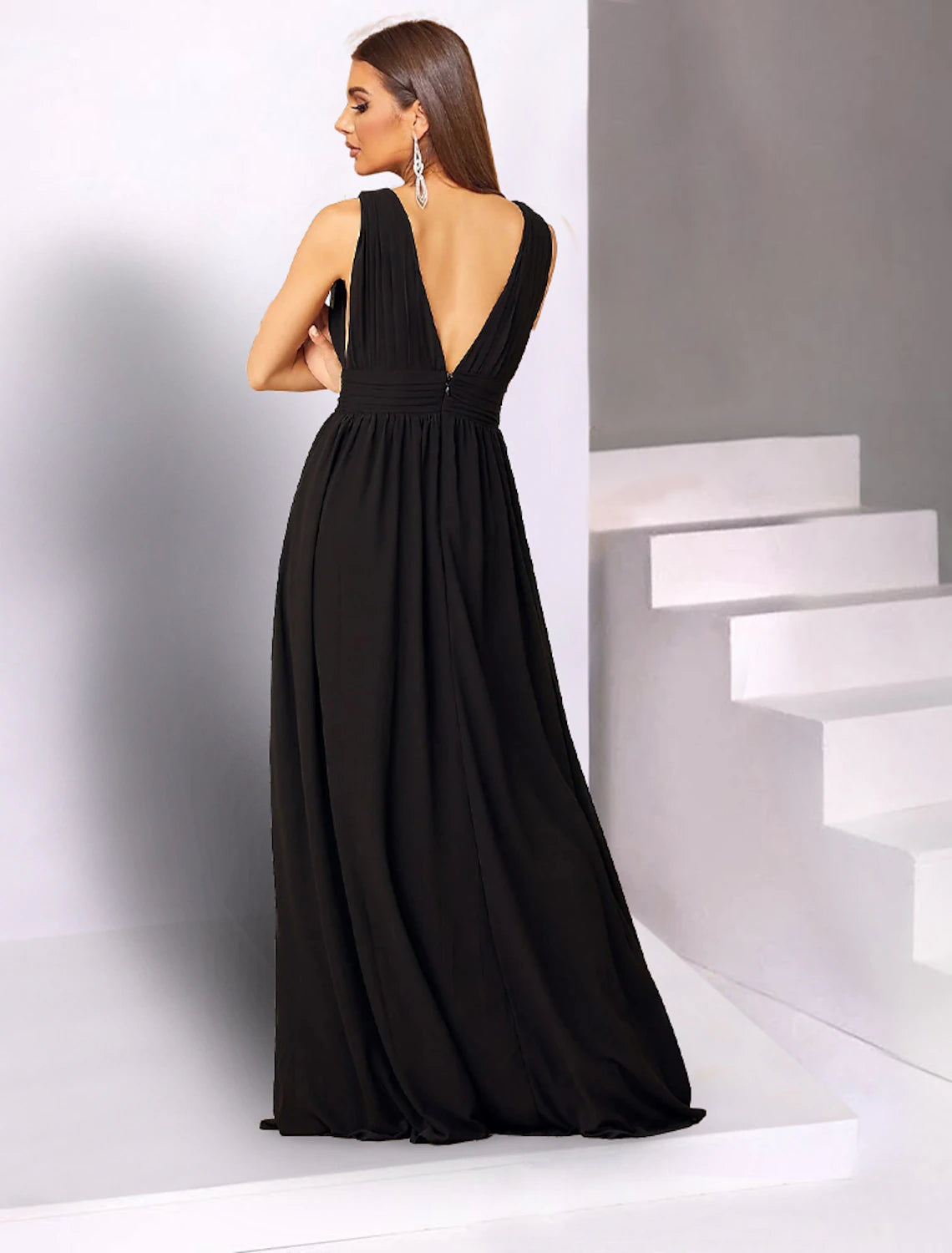 Back view of a floor-length sleeveless chiffon dress.