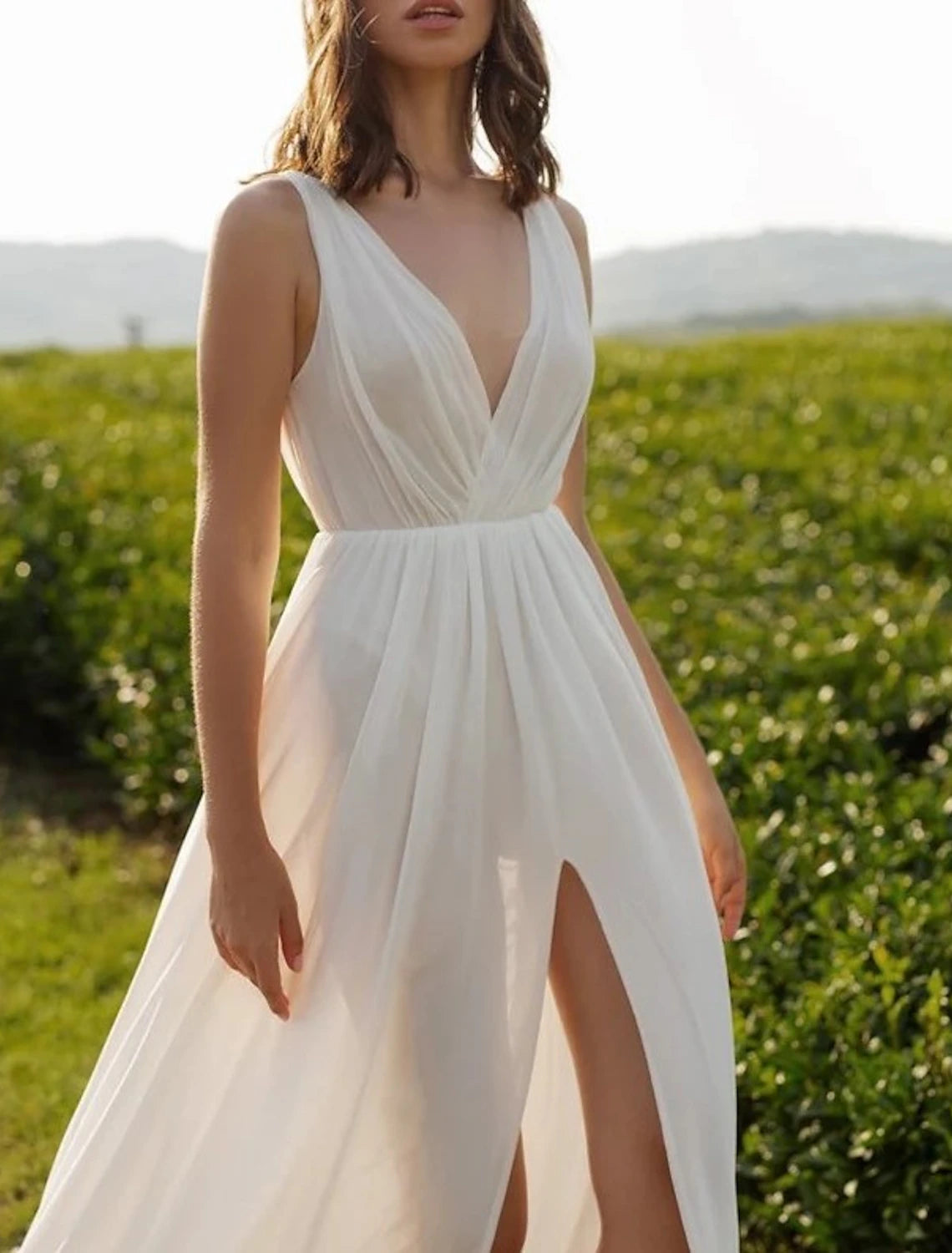 Back view of a white A-line V-neck chiffon wedding dress, highlighting the court train.