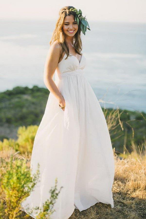Elegant A-line chiffon wedding dress with V-neck and spaghetti straps.