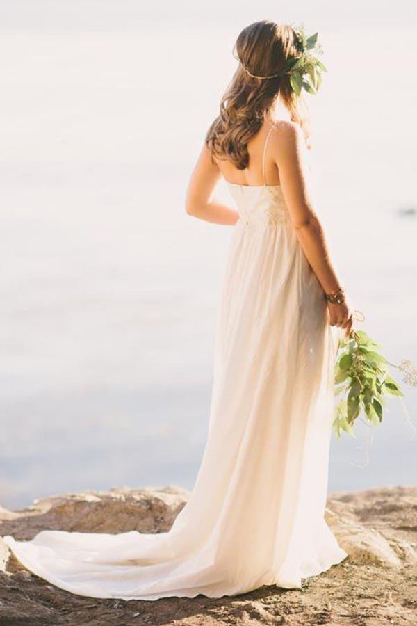 Full view of an A-line chiffon wedding dress featuring a V-neck, spaghetti straps, and a sweep train.