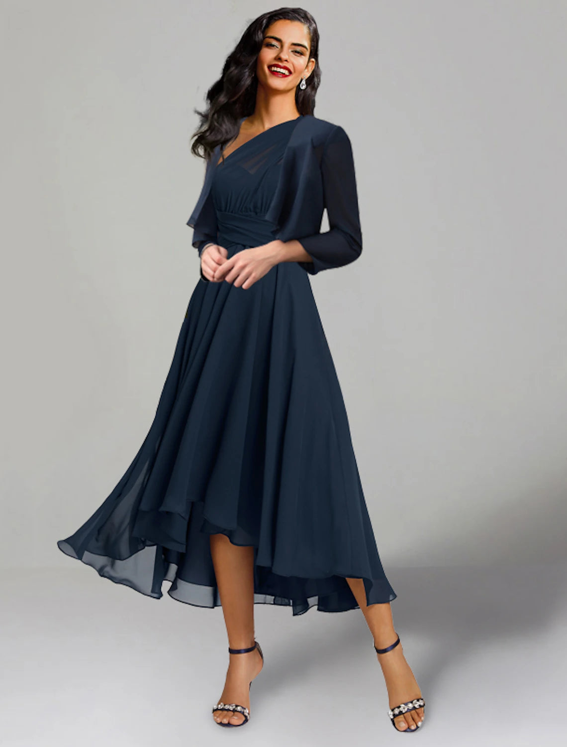 Back view of the A-line tea-length chiffon dress, highlighting the flow and silhouette.