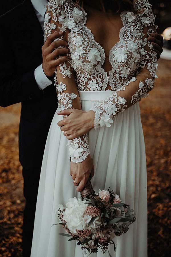 Close-up of delicate floral appliques on a chiffon wedding dress.