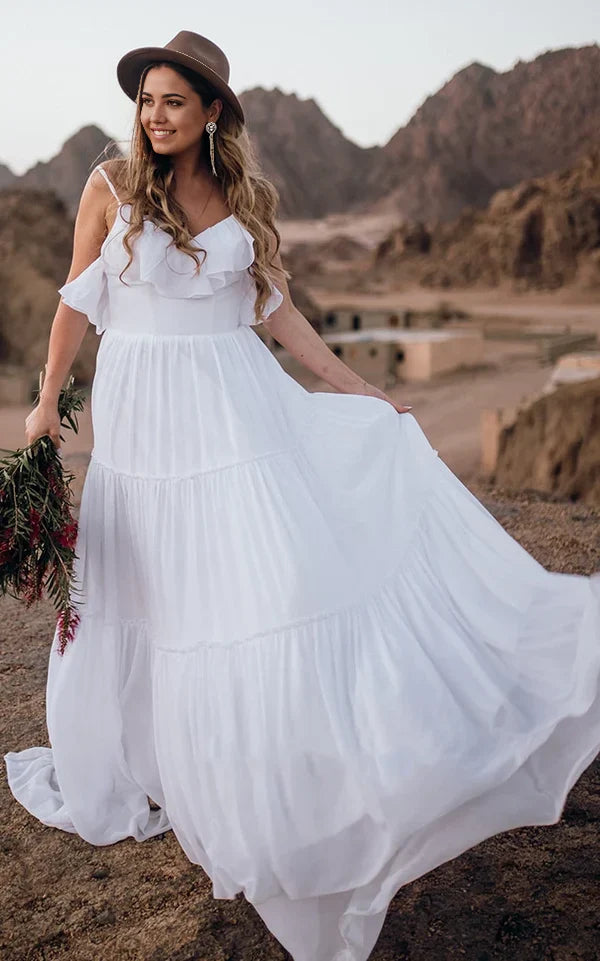 Elegant A-line chiffon wedding dress with spaghetti straps, ruffles, and an open back.