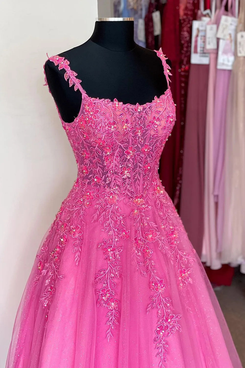 Back view of A-line prom dress showing flowing skirt and delicate straps.