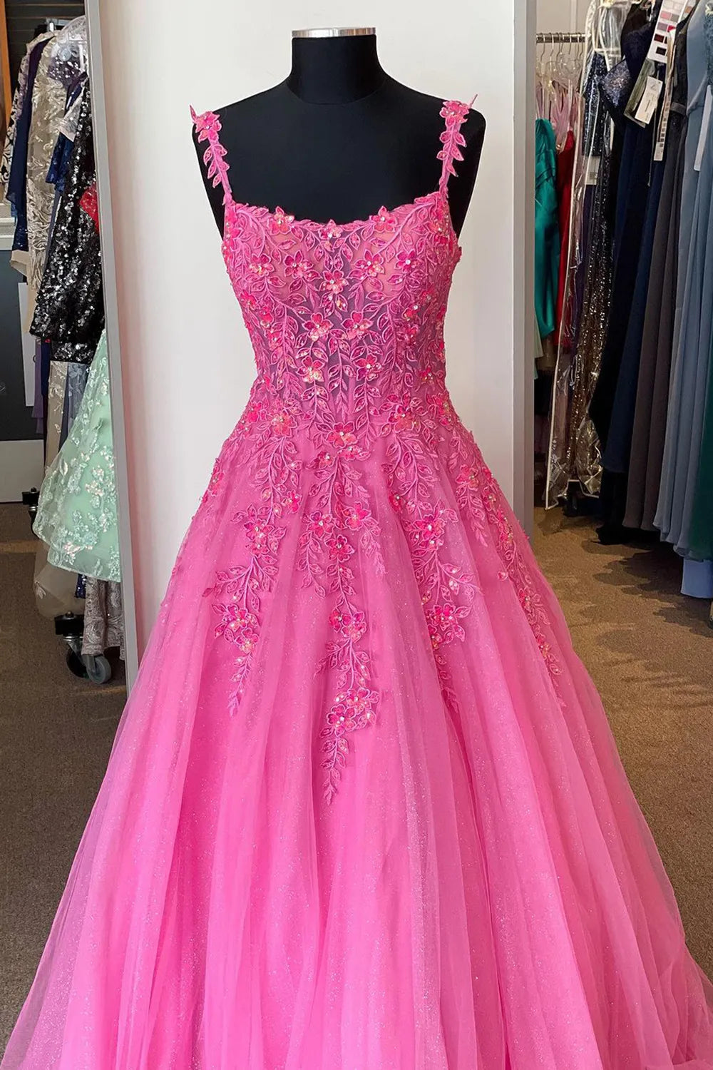 Close-up of corset bodice with intricate appliques on the V-neck prom dress.