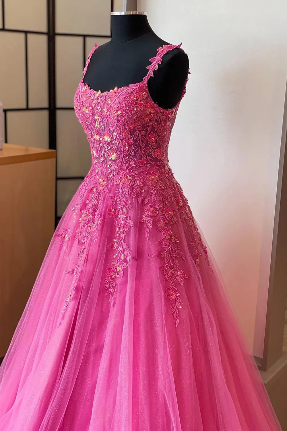 Side view of A-line prom dress, highlighting the silhouette and appliques.
