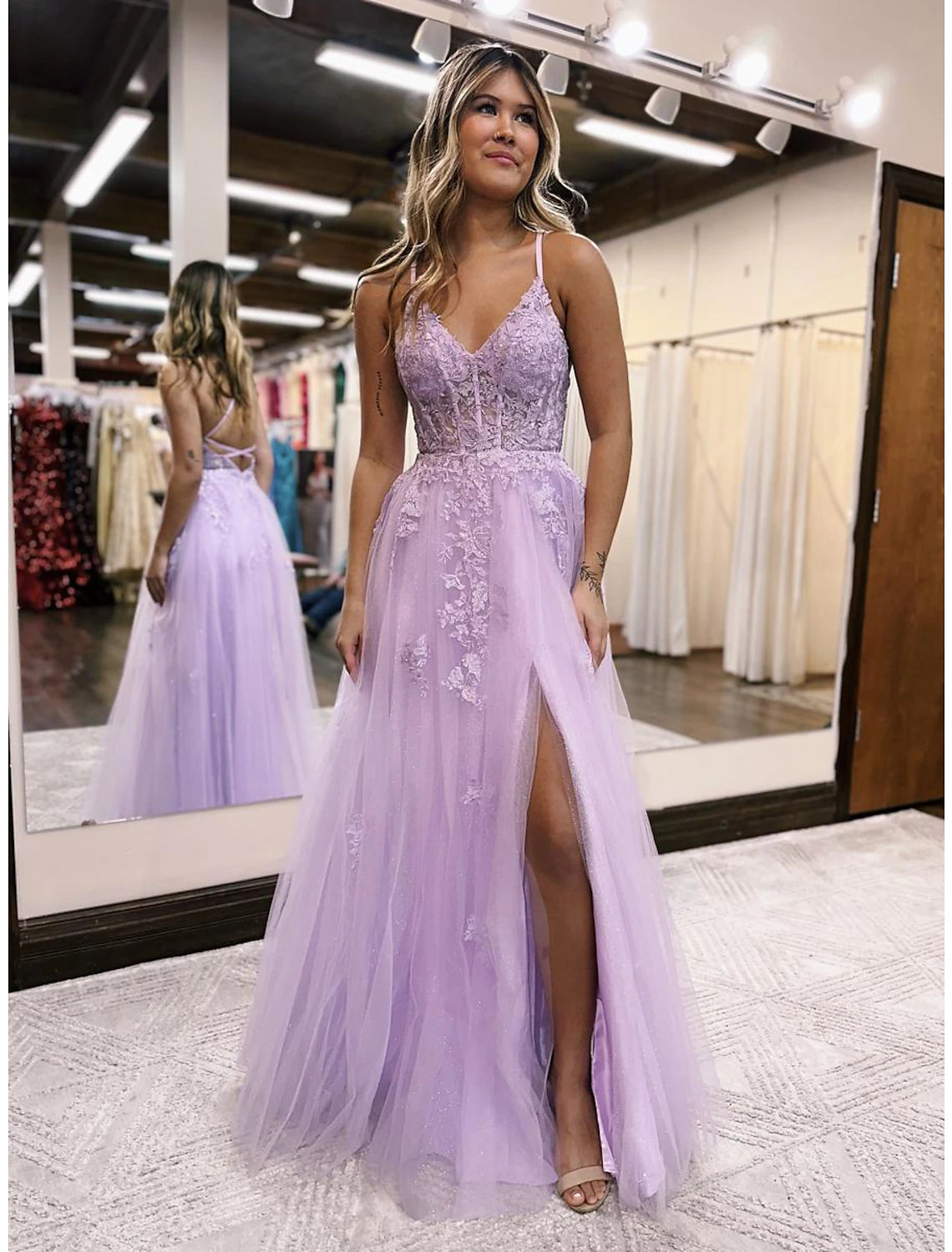 Side view of an A-line evening gown, showing the flowing skirt.