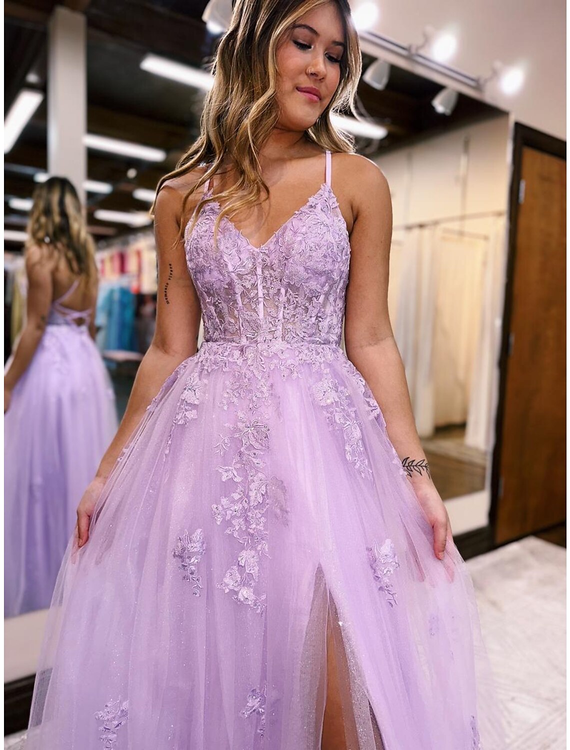 Close-up of the intricate beading and thigh-high slit on the evening gown.