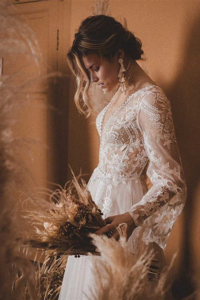 Wedding dress showcasing flare sleeves, an open back, and a flowing A-line skirt.