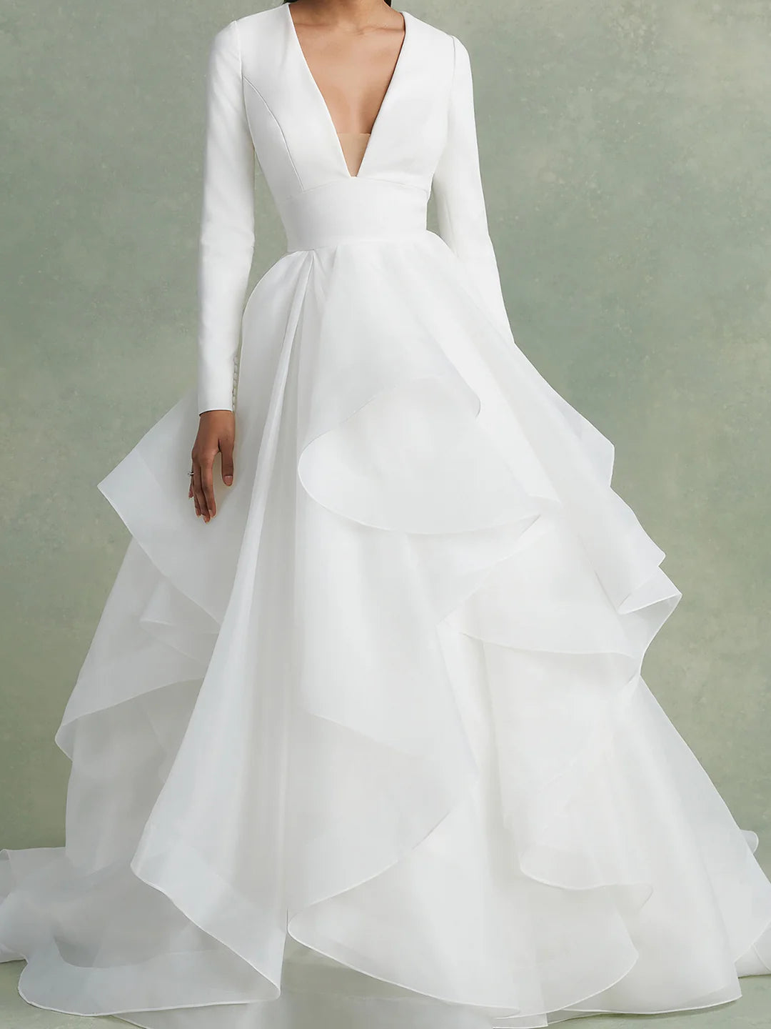 Close-up of the V-neckline and bodice details of the wedding dress.