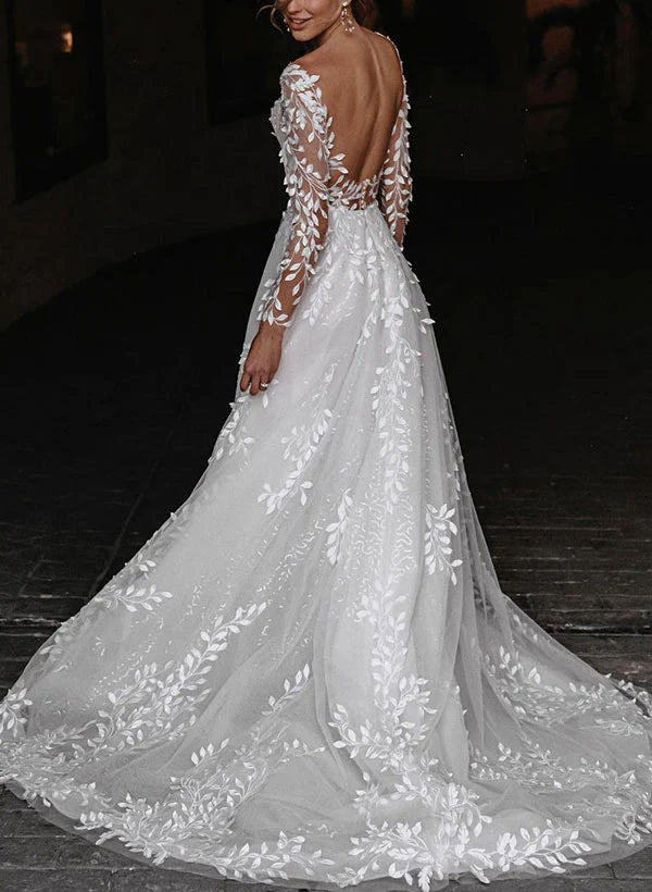 Close-up of the V-neckline and bodice of the white A-line wedding dress.