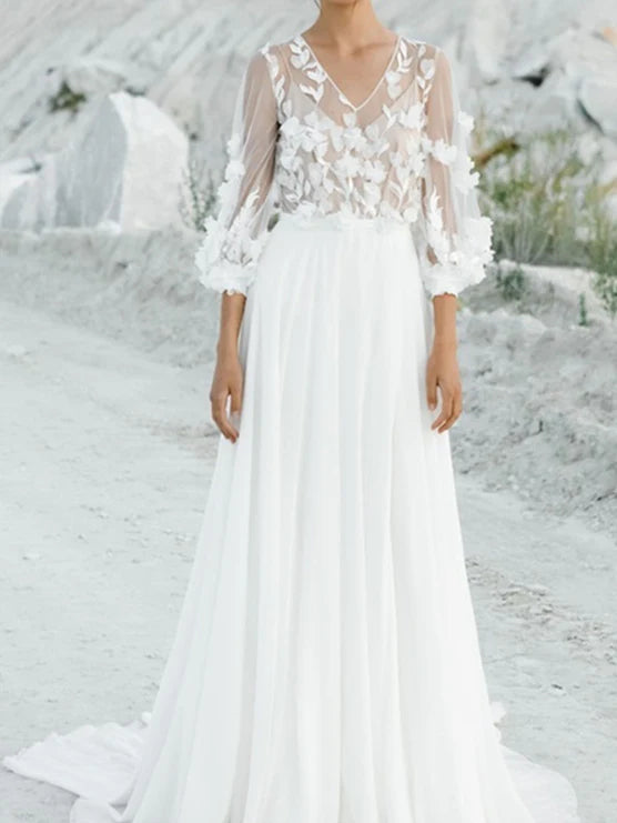 Woman wearing an elegant A-line V-neck wedding dress with floral appliques.