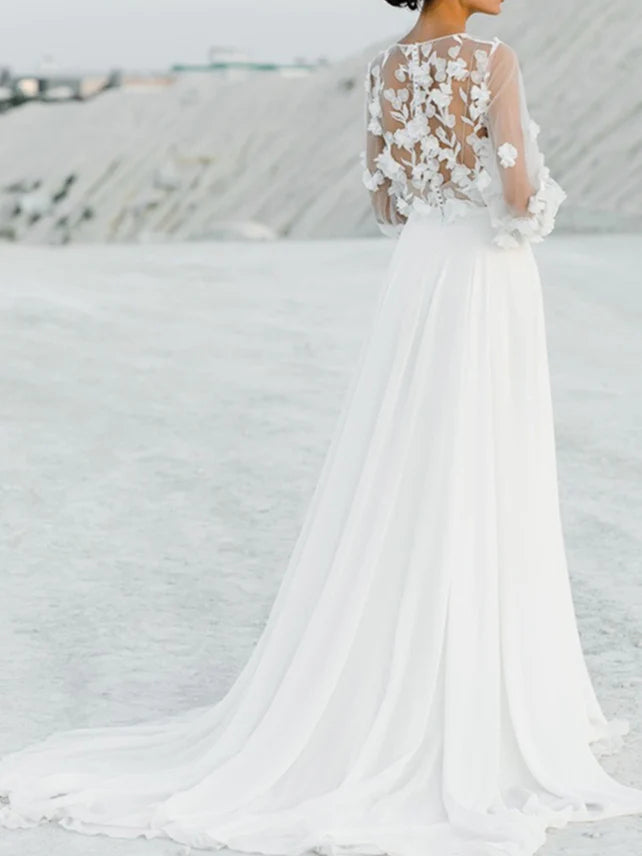Back view of a bride in a floor-length A-line wedding gown with intricate appliques.