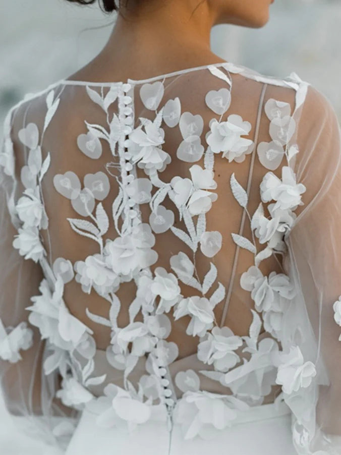 Full view of an A-line wedding dress with a V-neck and appliques, perfect for a bride.