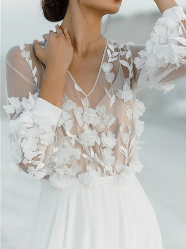 Side profile of a sleeveless A-line wedding dress with appliques and a flowing skirt.