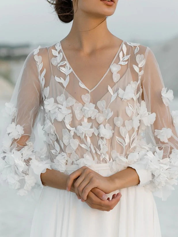 Elegant bridal gown featuring a V-neck, A-line silhouette, and detailed appliques.