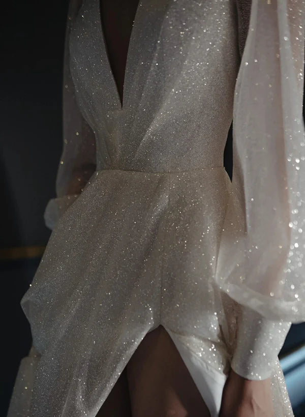 Side view of an A-line V-neck bridal gown with a delicate train.