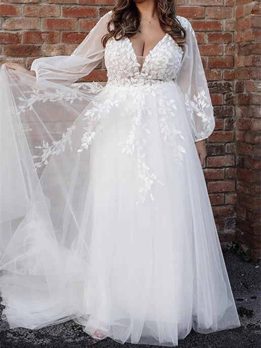 Elegant A-line V-neck floor length wedding dress on a model.