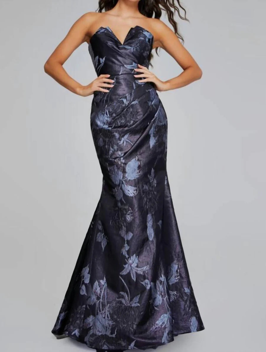 Back view of the elegant floral gown showing asymmetrical hem.