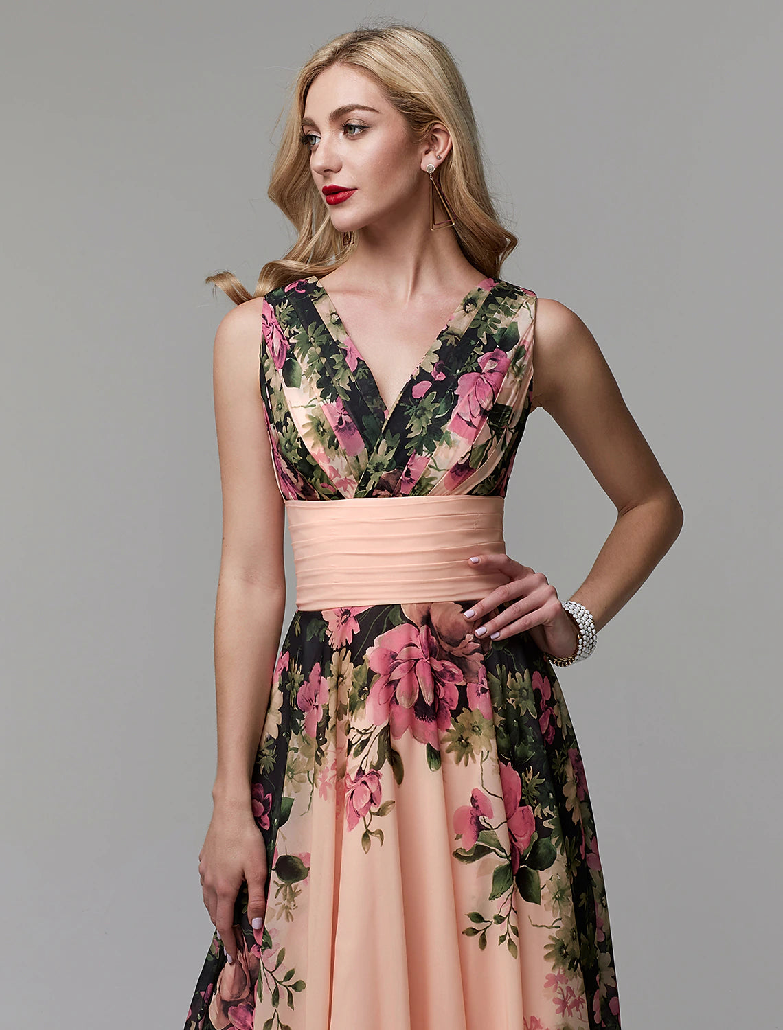 Model posing in the flowing A-line floral chiffon floor length dress.