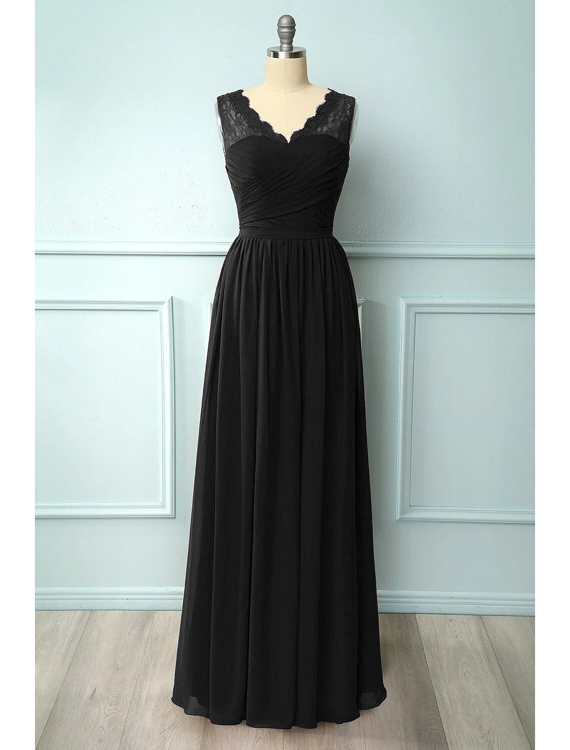 Side profile of a V-neck chiffon party dress with delicate floral embellishments.