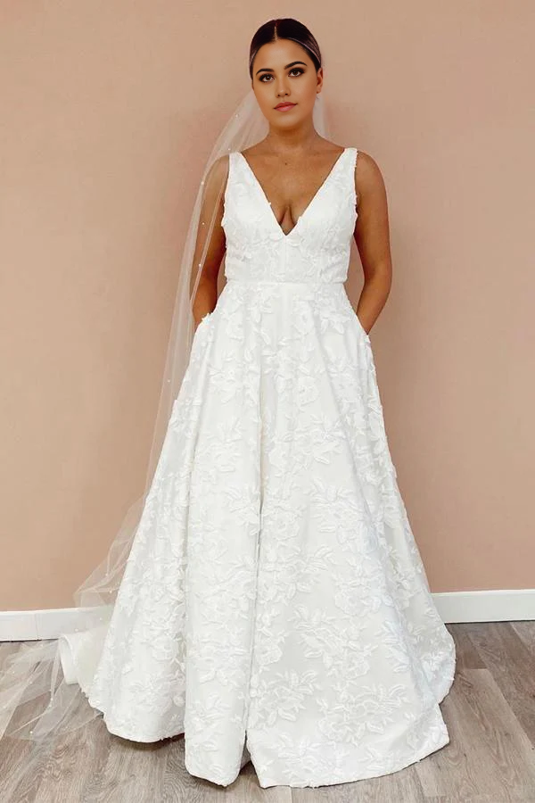 A-line wedding dress with illusion V-neckline and floral lace back.