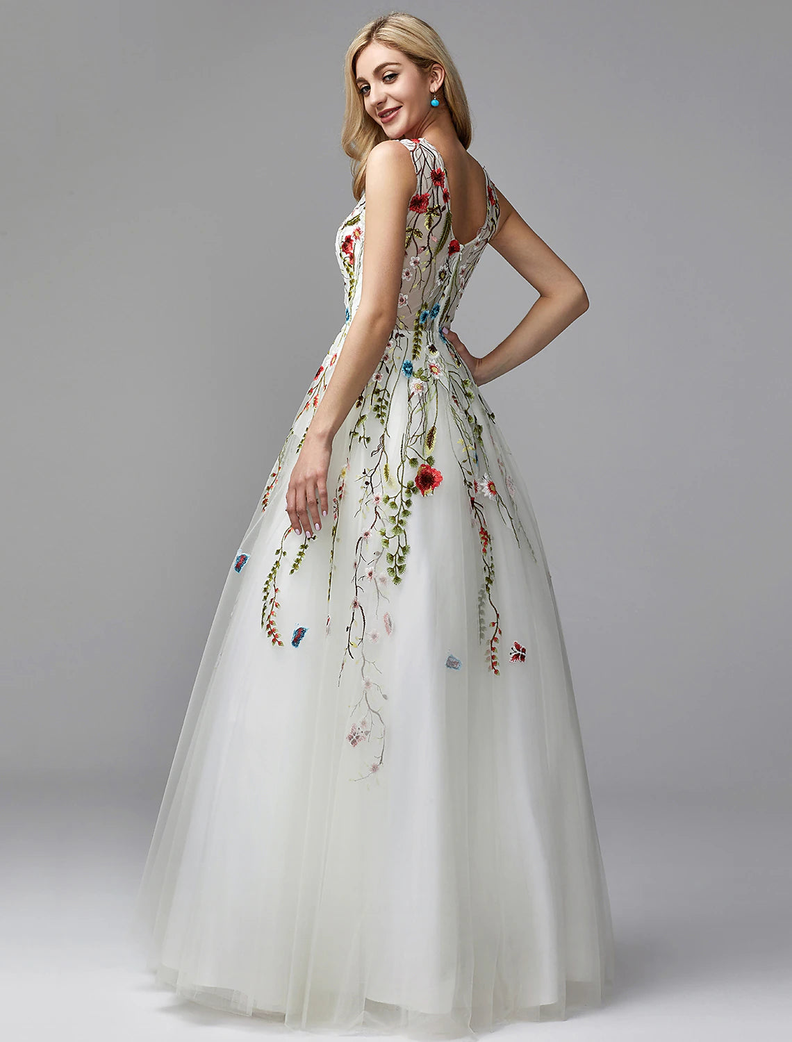 Close-up of V-Neckline and floral lace embroidery on dress.