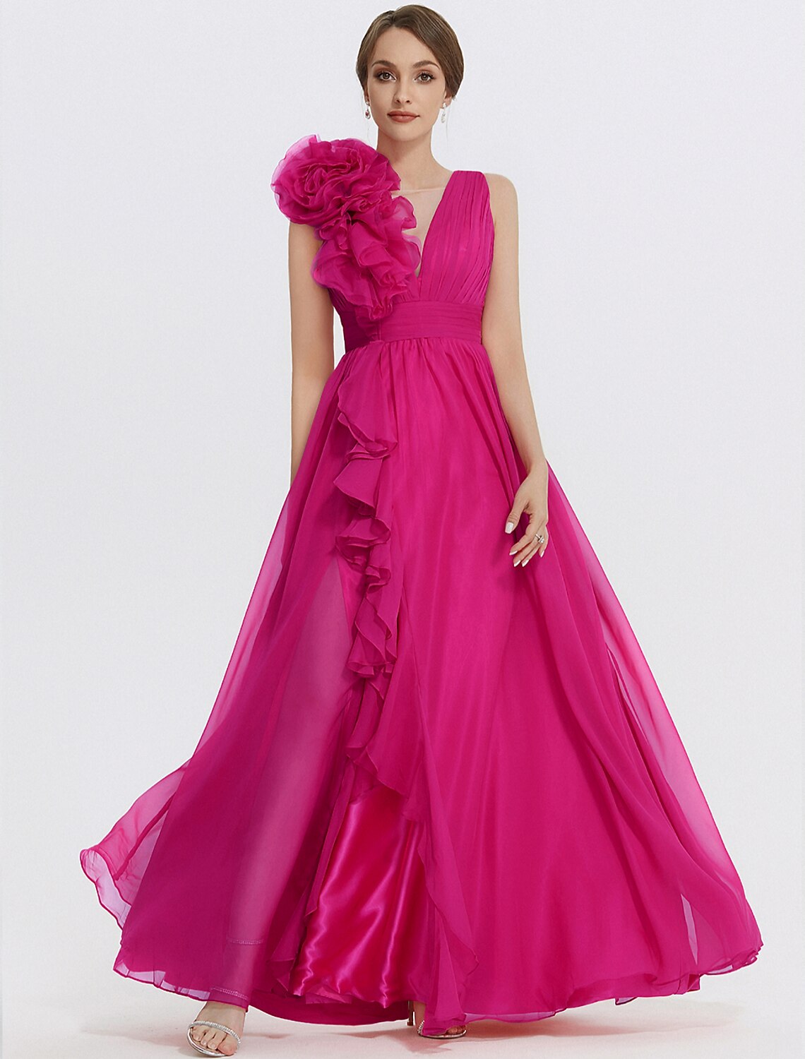 Side profile of a sleeveless floral wedding guest gown.