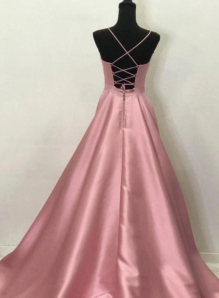 Model showcasing a flowy champagne V-neck satin formal gown.
