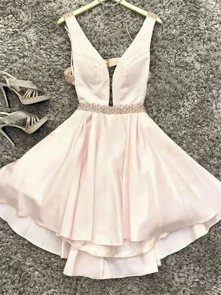 Woman wearing an elegant V-neck A-line short satin dress.