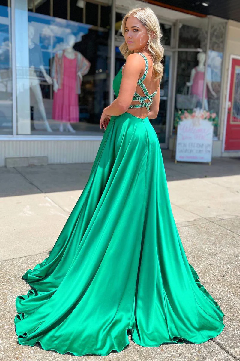 Back view of a long green satin A-line dress, showcasing the flowing skirt.