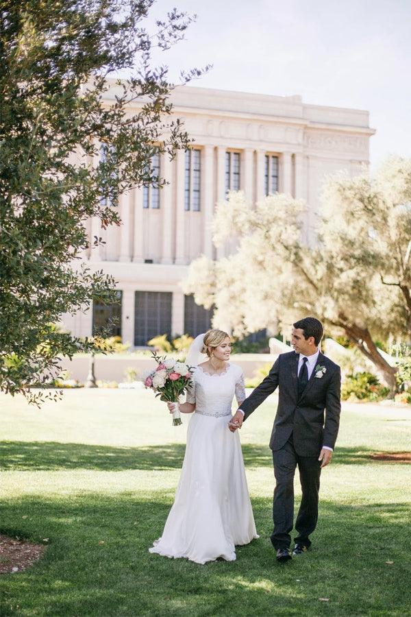 Ivory A-line wedding dress with V-neck and half sleeves, featuring delicate beading and lace details.