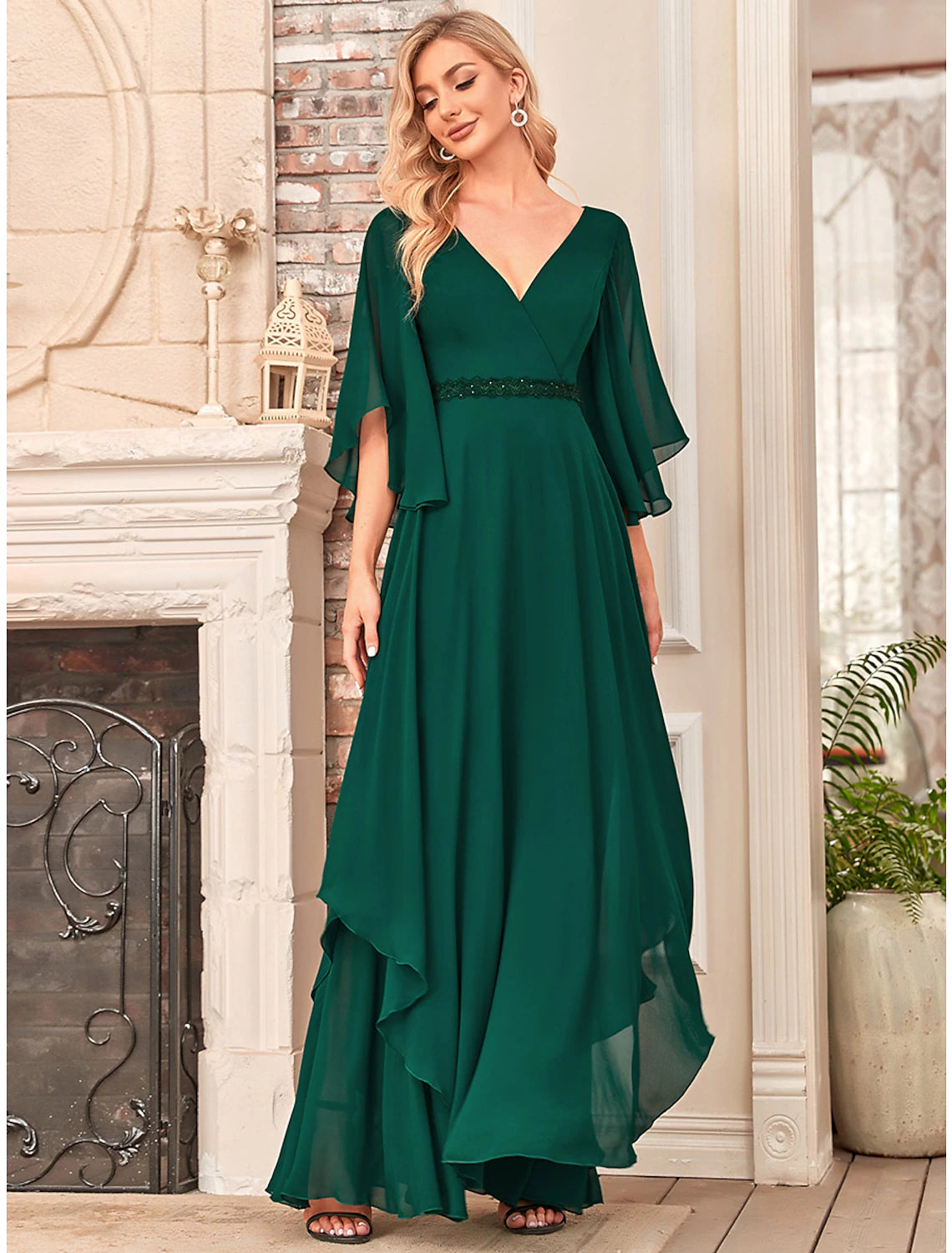 Floor-length chiffon dress with a delicate sash detail.