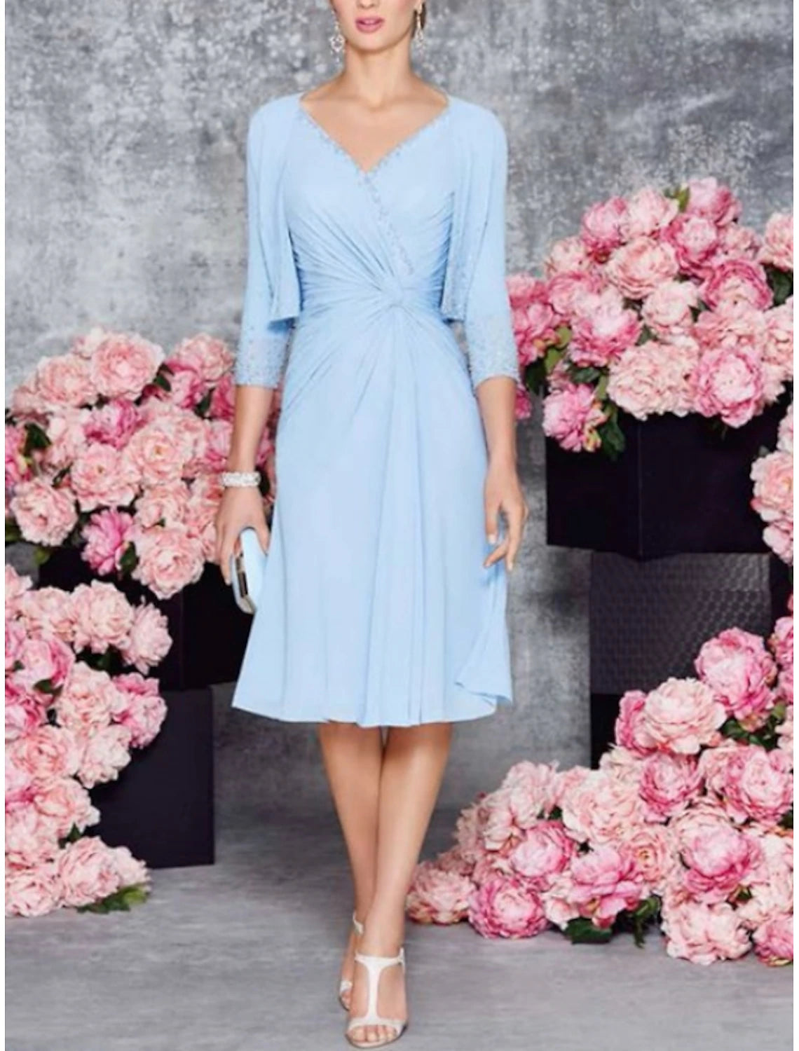 Front view of an elegant A-line V-neck knee-length dress with half sleeves and ruching.
