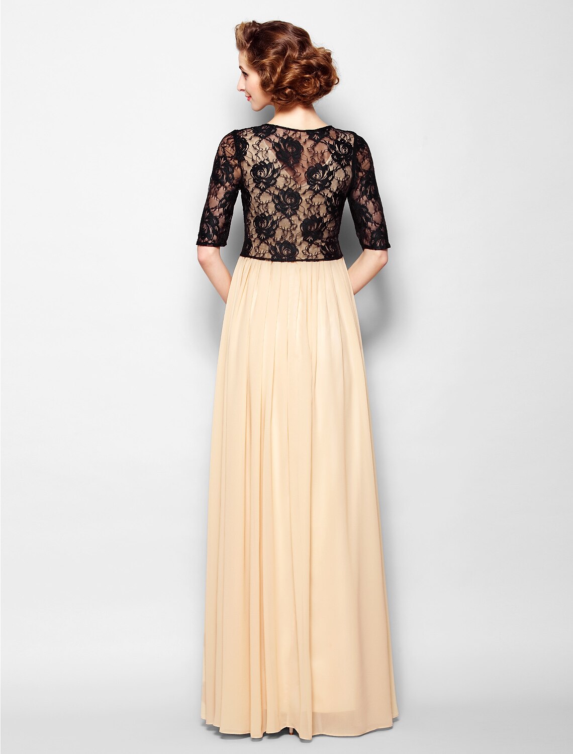 Close-up of the V-neckline and lace half sleeve on the dress.