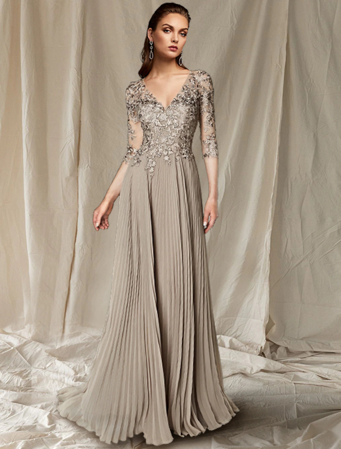 Elegant A-line V-neck chiffon lace gown with half sleeves.