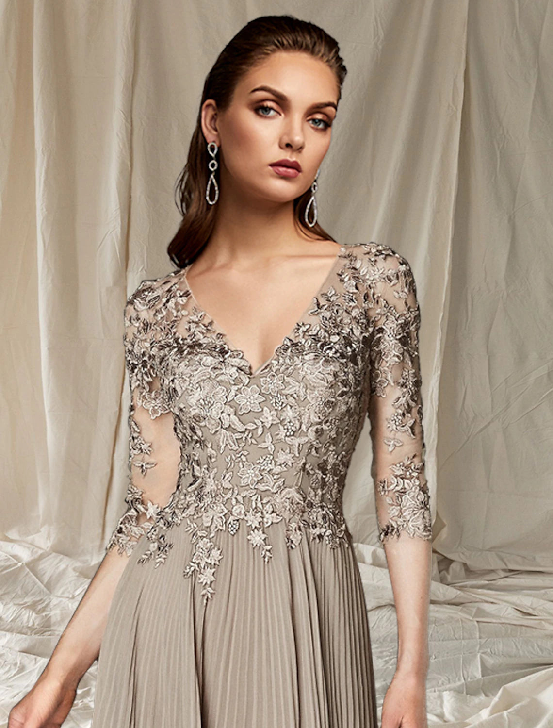 Close-up of lace appliques and V-neckline on the dress.