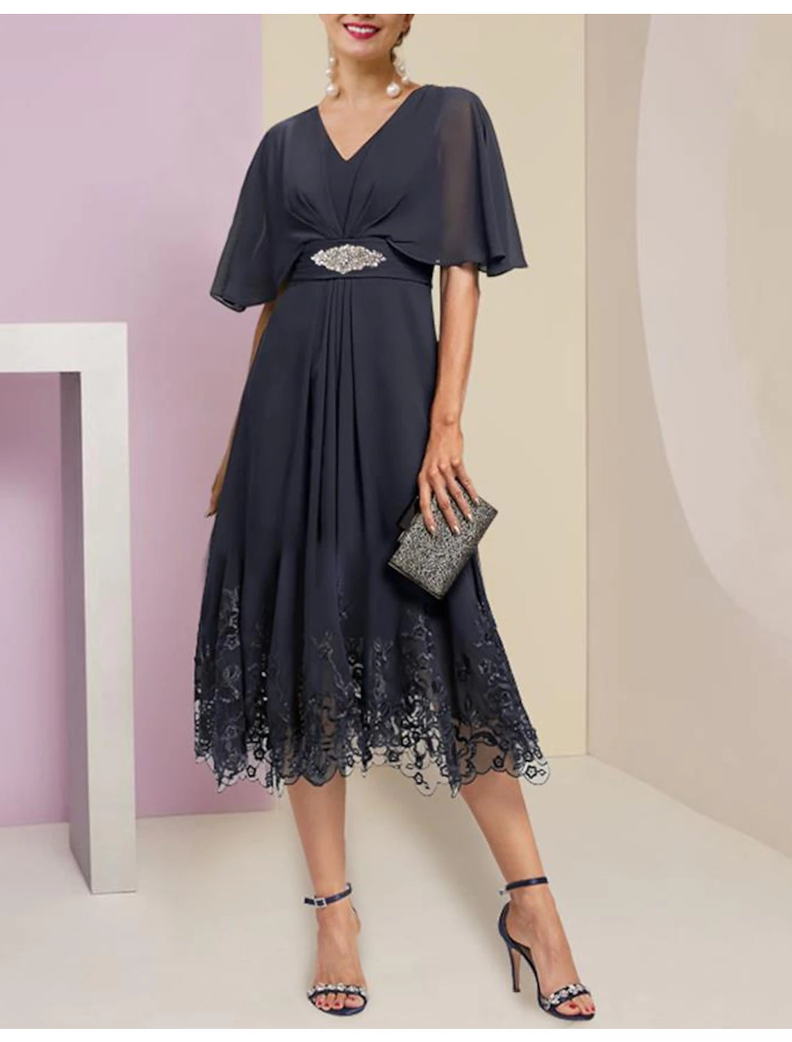 Elegant A-line V-neck tea-length dress with half sleeves and lace appliques.