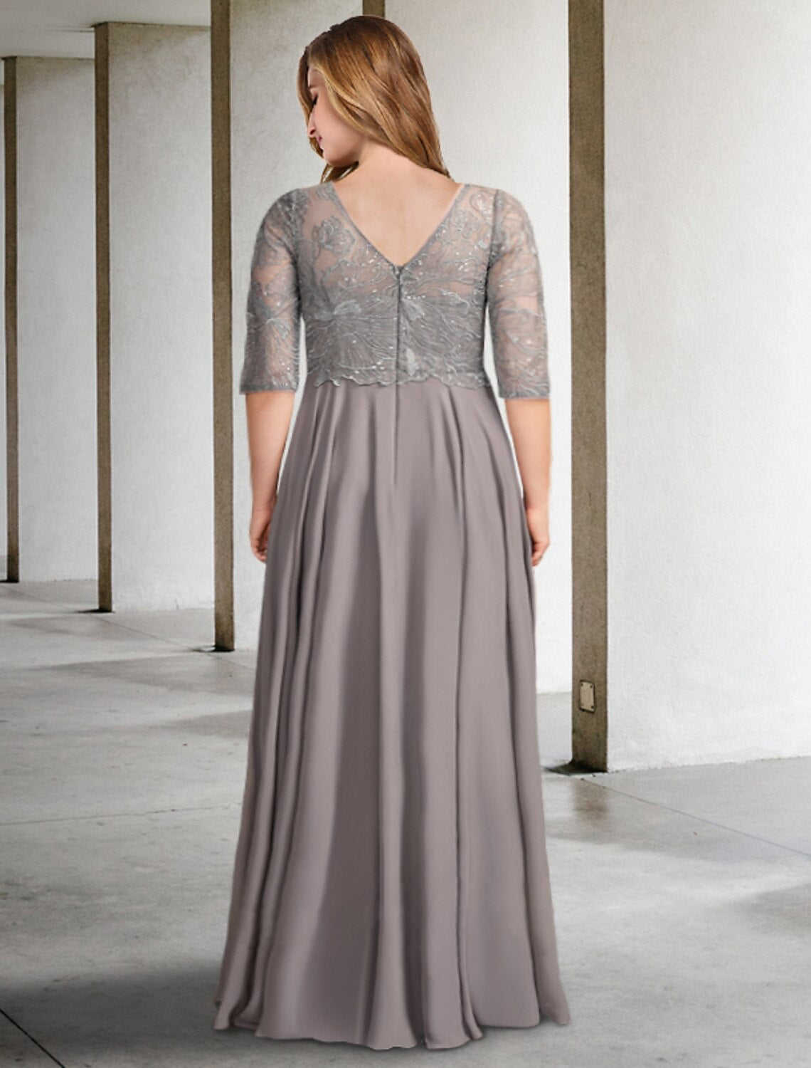 Back view of the formal chiffon gown featuring pleats and sequin appliques.