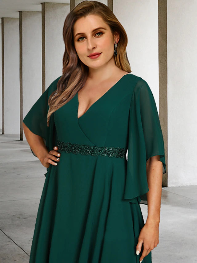 Back view of an elegant A-line plus size mother of the bride dress with a sweep train.