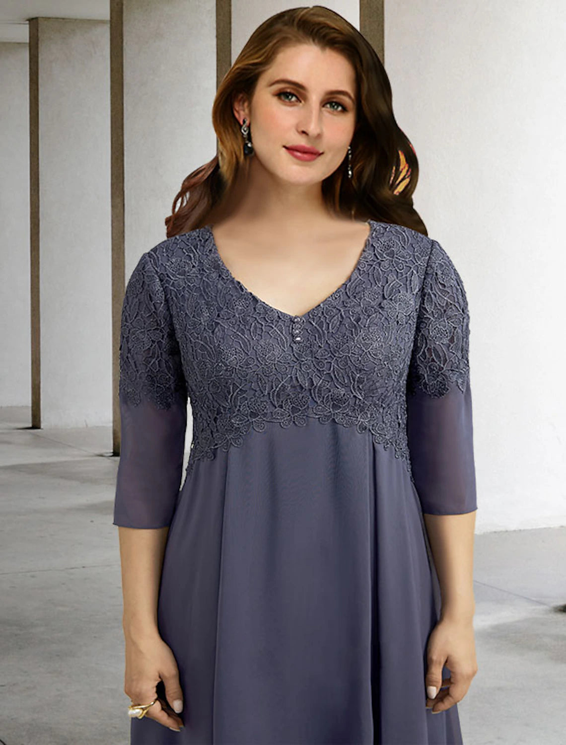 Back view of an elegant A-line V-neck half sleeve chiffon tea length Mother of the Bride dress with button details.