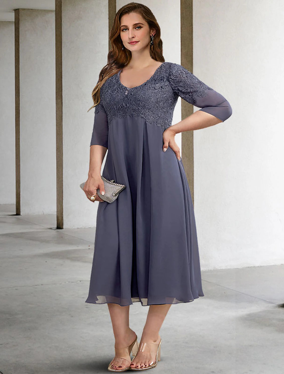 Close-up of the V-neckline and half sleeves of an elegant chiffon Mother of the Bride dress.