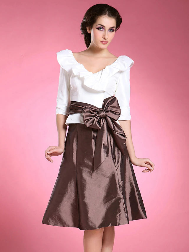 Close-up of the color block detail and sash on the Mother of the Bride dress.