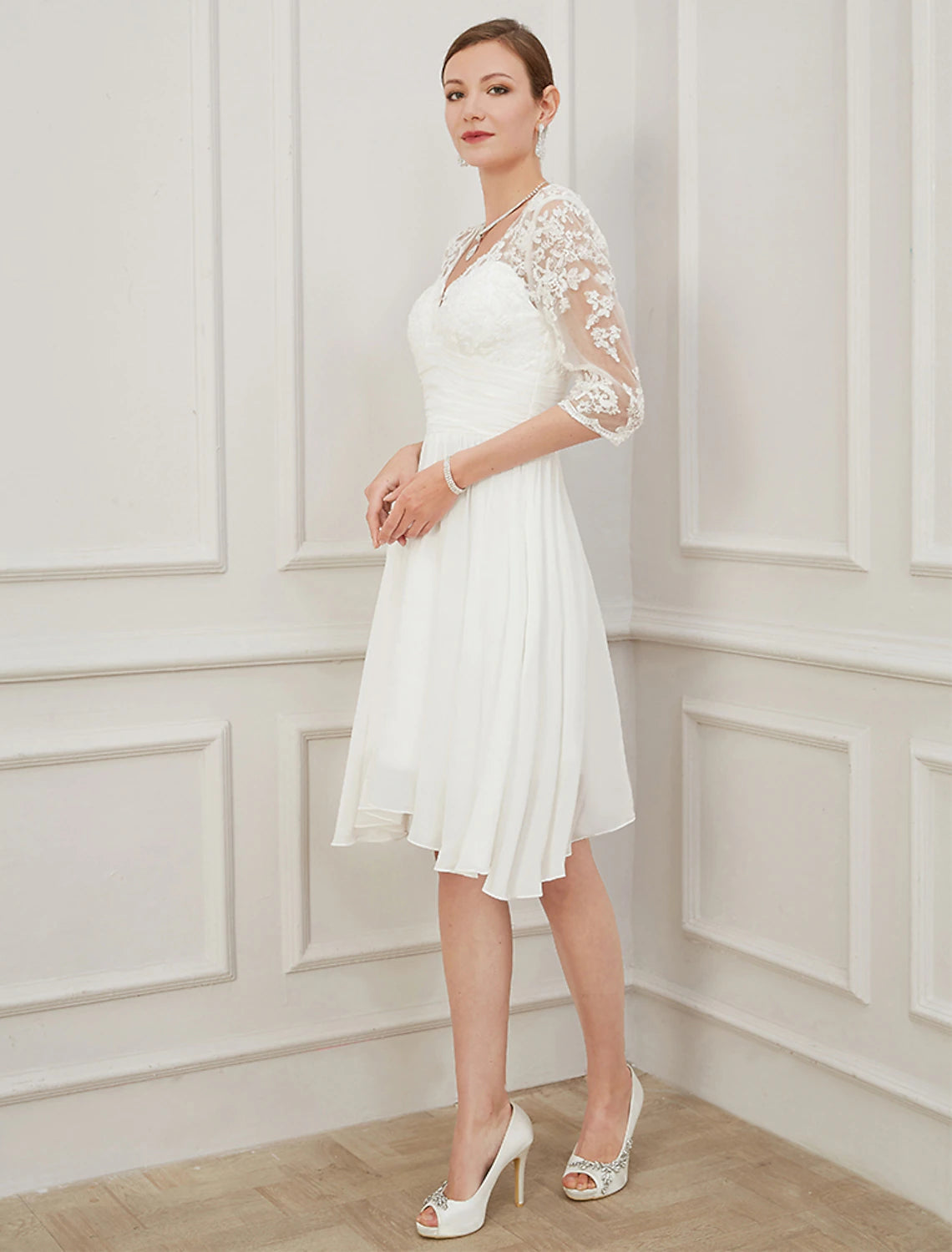 Close-up of the V-neckline and applique details on the half-sleeve dress.