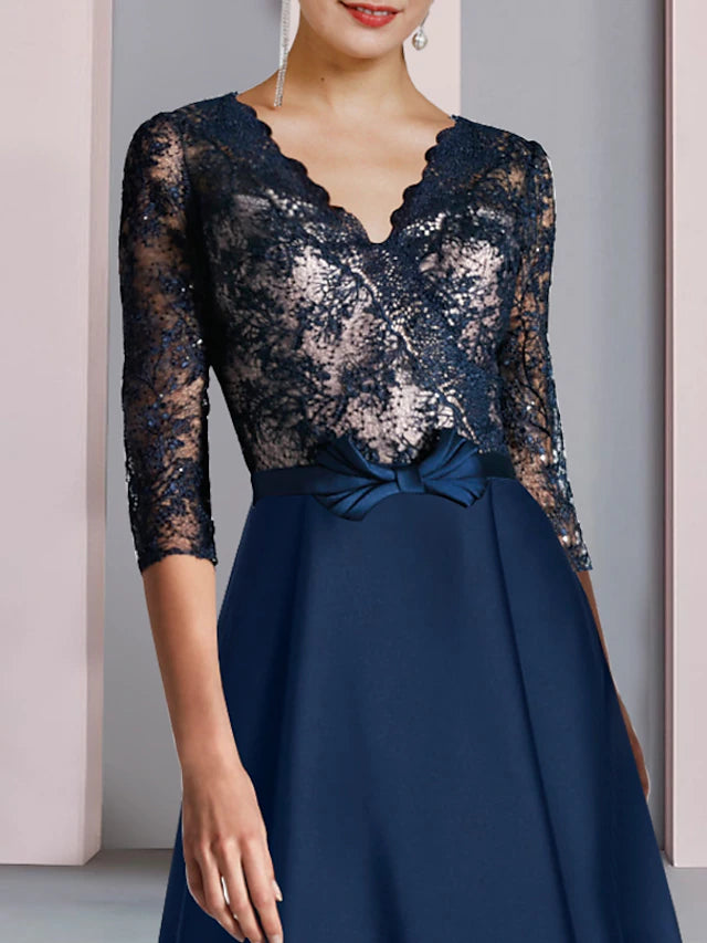 Back view of the A-line V-neck half sleeve high-low tea length dress with bow detail.