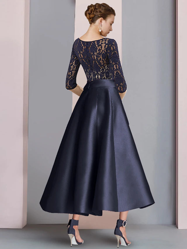 Close-up of the V-neckline and half sleeves with lace embellishment on the dress.