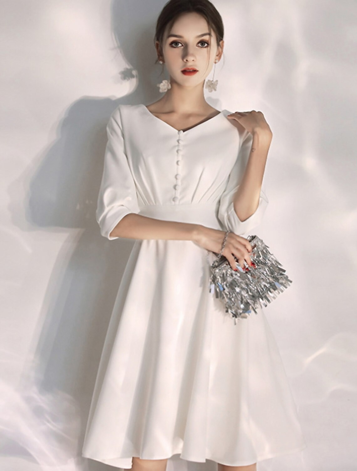 Model posing in the A-line knee-length bridal gown, emphasizing its comfortable fit.
