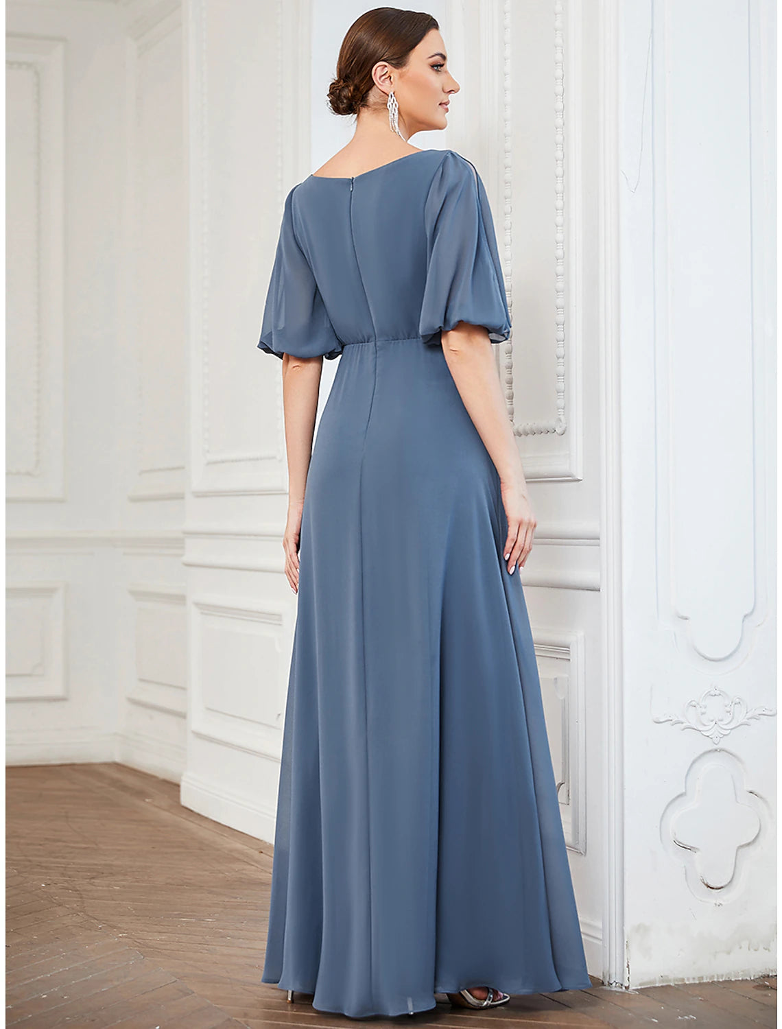 Woman posing in an elegant A-line V-neck half sleeve pleated chiffon dress.