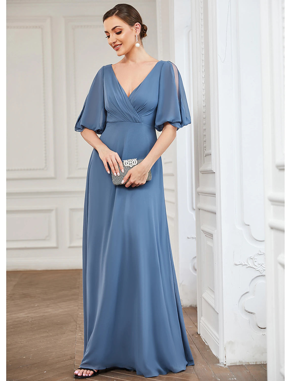 Side view of a woman in an A-line V-neck half sleeve chiffon dress.