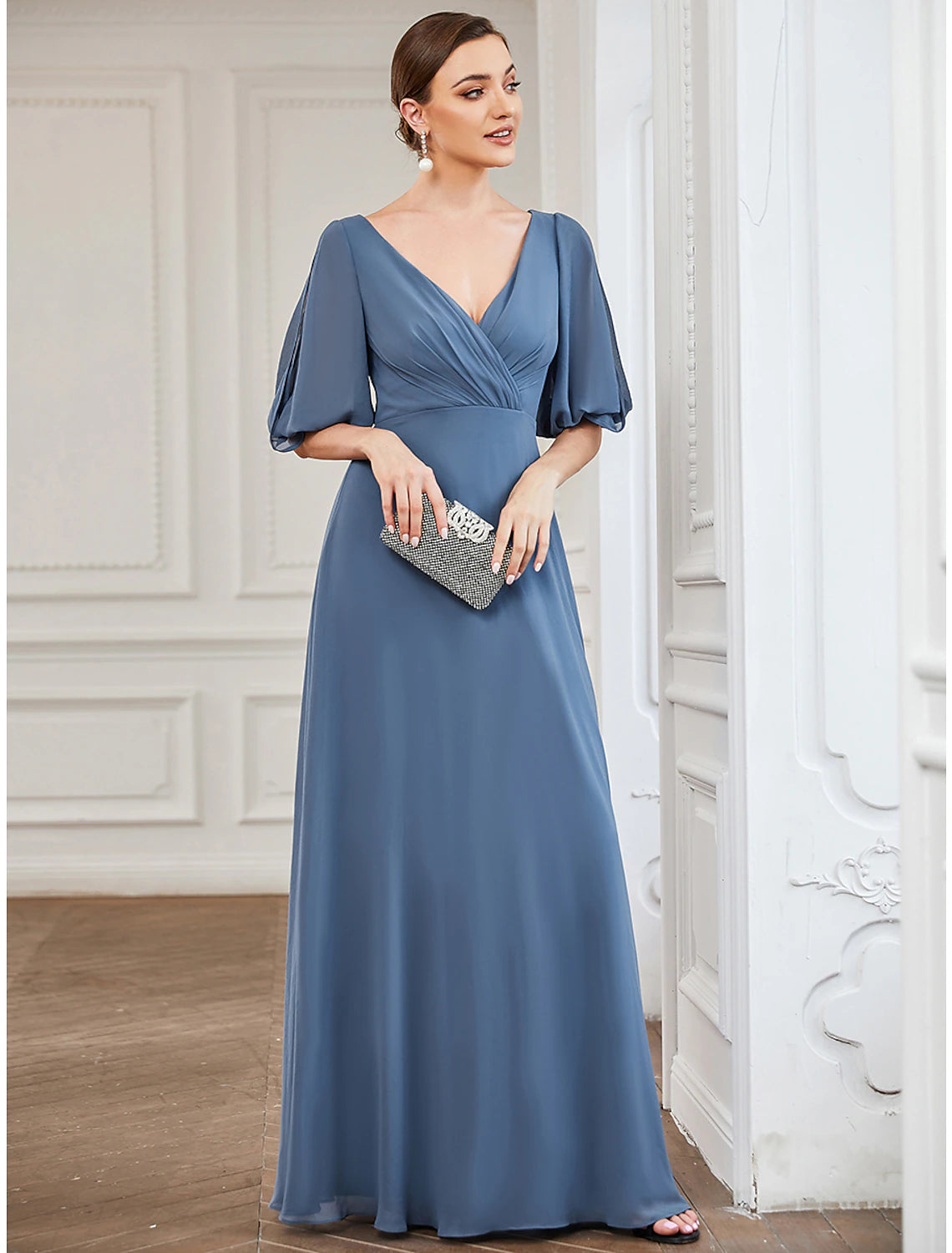 Close-up of the V-neck and half sleeve details on a chiffon evening gown.